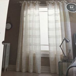 Ivory pleated semi-sheer window panels